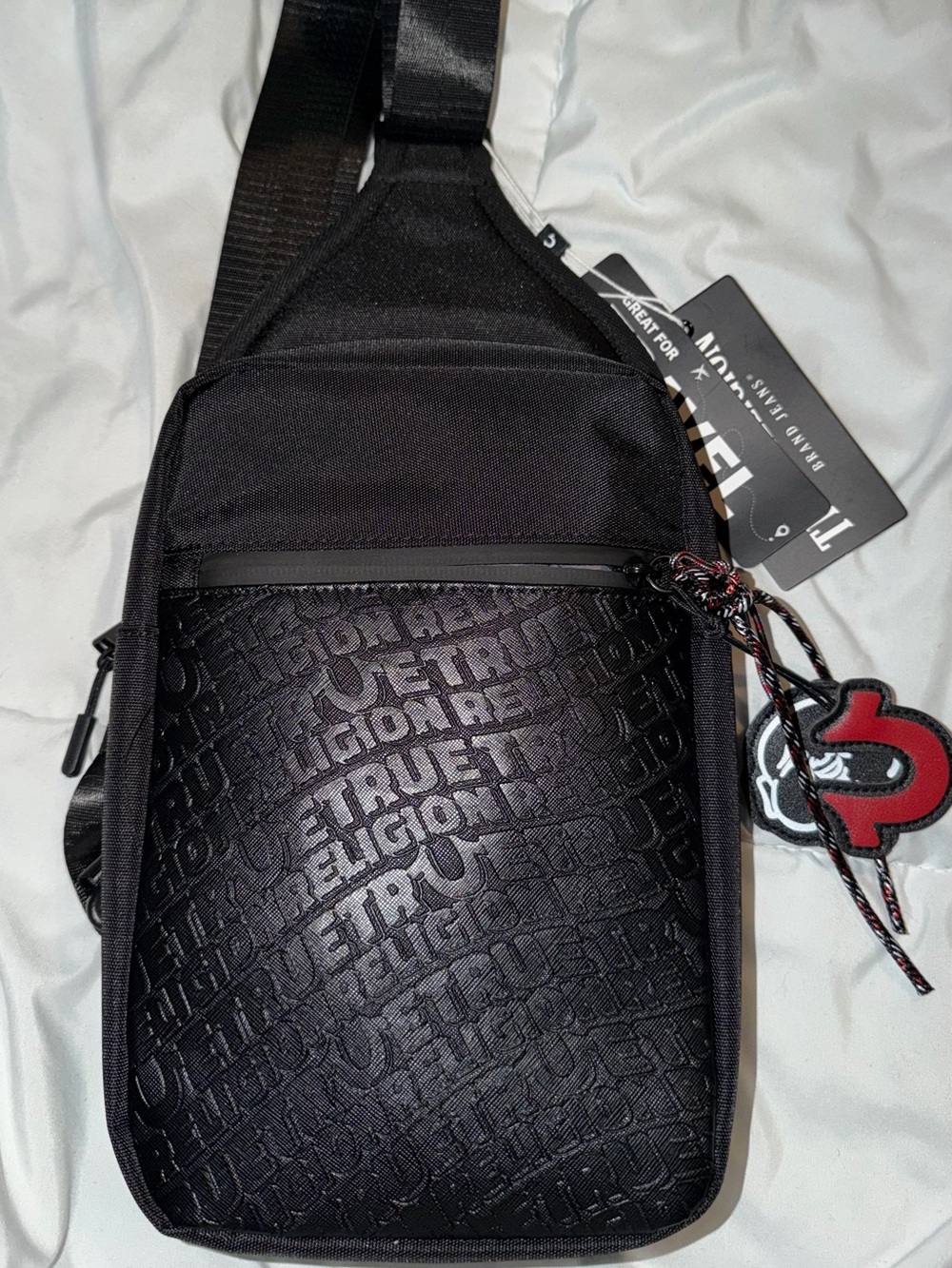 True Religion Black Embossed Logo Sling Bag with Red Accent Charm